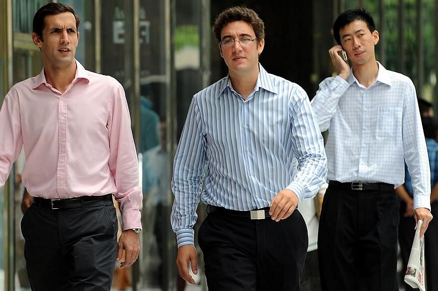 Office workers walking past the Raffles Place MRT station during lunch time in this file photo. --STPHOTO: JOYCE FANG