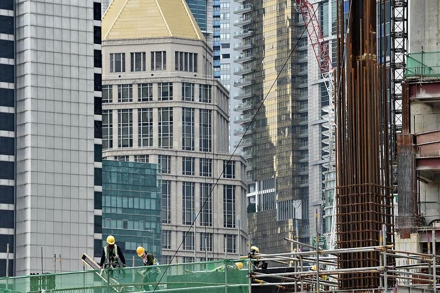 The latest set of economic numbers, released by the Ministry of Trade and Industry on Tuesday morning, show that property cooling measures and foreign manpower curbs have started to bite, economists said. -- PHOTO: AFP