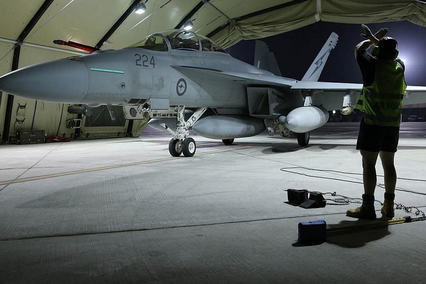 A Royal Australian Air Force F/A-18F Super Hornet aircraft coming to a stop in its hangar in the Middle East. -- PHOTO: AFP