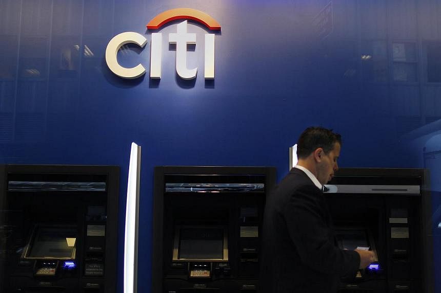 A man walks past a Citibank branch in lower Manhattan, New York. Citigroup says it will exit consumer banking in 11 more markets, as the most international of the big U.S. banks looks to shrink its way to better profits. -- PHOTO: REUTERS
