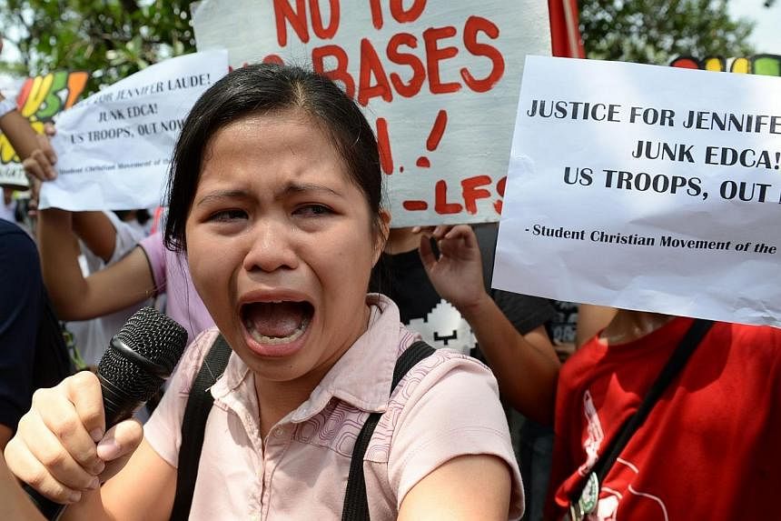 A Filipino student leader speaks as she becomes emotional during a rally in front of the US embassy in Manila on Oct 14, 2014 as protesters condemned the murder of a local transgender person and the presence of US troops.&nbsp;The Philippines on Wedn