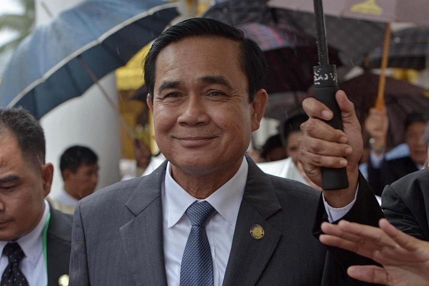 Thai junta leader and Prime Minister Prayut Chan-O-Cha smiles as he visits the Shwedagon pagoda as part of his official visit to Myanmar on Oct 10, 2014. -- PHOTO: AFP