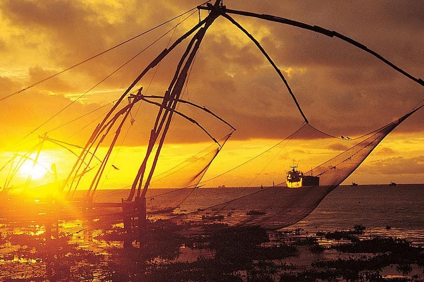 The Chinese fishing nets in Fort Kochi. These giant cantilevered nets look like something out of the Flintstones, their crude wooden frames fixed to the shore and then lowered manually in and out of the water. -- PHOTO: ST FILE