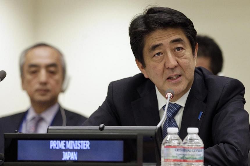 Japan's Prime Minister Shinzo Abe addresses a high-level summit on strengthening international peace operations during the 69th session of the United Nations General Assembly at United Nations headquarters in New York. -- PHOTO: REUTERS