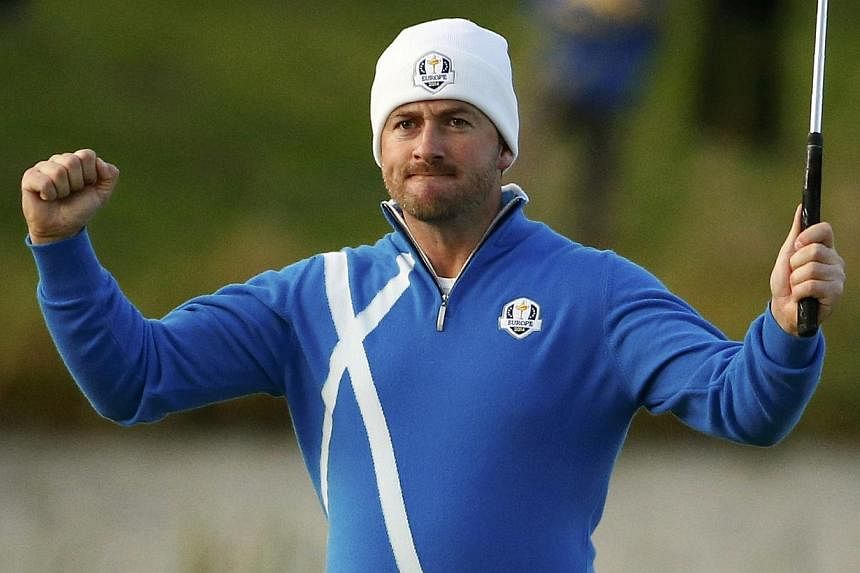 European Ryder Cup player Graeme McDowell celebrates on the 17th green after winning his foursomes 40th Ryder Cup match at Gleneagles in Scotland Sept 26, 2014. McDowell predicted on Tuesday that the bitter fallout from the United States' Ryder Cup l