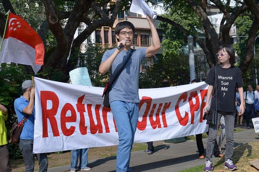 Roy Ngerng (centre) and Han Hui Hui (right) speaking at the Return Our CPF rally at Hong Lim Park on Sept 27, 2014. -- ST PHOTO: LIM SIN THAI&nbsp;