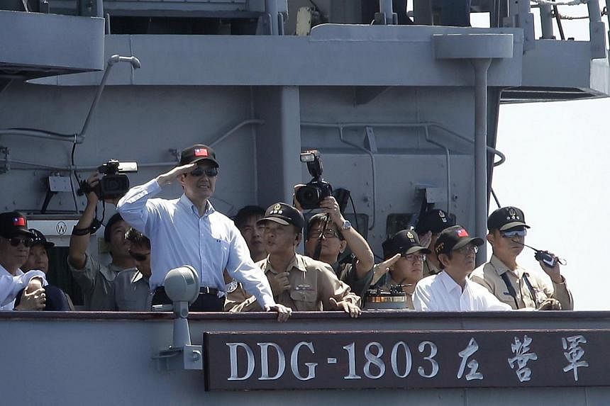 Taiwan's President Ma Ying-jeou salutes navy officers on a Kidd-class destroyer during a military exercise. Taiwan is considering stationing armed vessels permanently on a disputed South China Sea island, officials said. -- PHOTO: REUTERS&nbsp;
