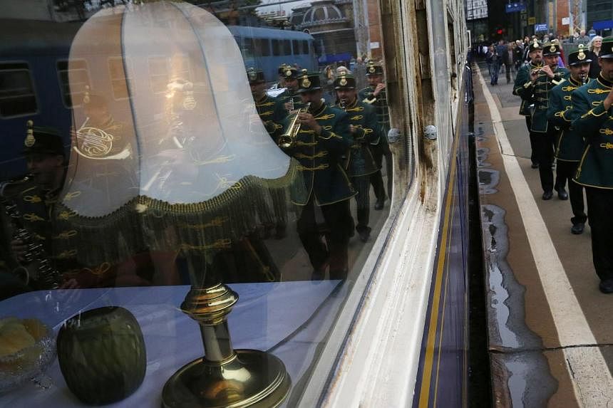 A marching band greets a historic Tehran-bound train in Nyugati Terminus in Budapest October 15, 2014. The train, a set of luxury cars retrofitted from historic models to reflect times gone by, will take two weeks to wind through the 7,000km journey 