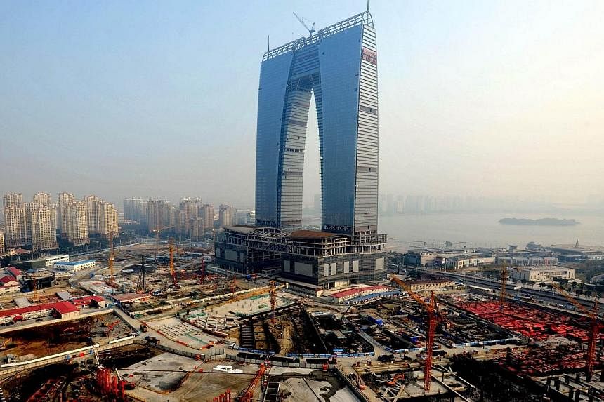 This picture taken on May 1, 2014 shows the 301.8-meter arch-shaped building which will house 69 stores, a luxury hotel, offices and shopping mall in Suzhou, eastern China's Jiangsu province. -- PHOTO: AFP