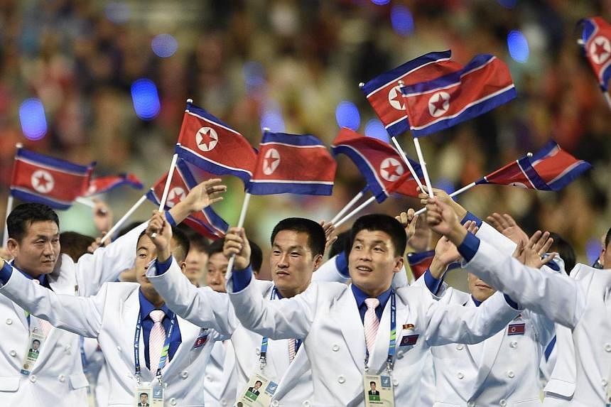 North Korean athletes wave their national flag as they parade during the closing ceremony of the 2014 Asian Games at The Incheon Asiad Main Stadium in Incheon on Oct 4, 2014.&nbsp;South Korea said on Thursday that it would pay more than 70 per cent o