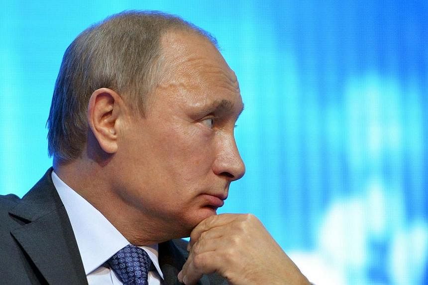 Russian President Vladimir Putin accused his US counterpart Barack Obama of a hostile approach towards Russia, warning in a Cold War-style tirade that Moscow would not be blackmailed by the West over Ukraine. -- PHOTO: AFP