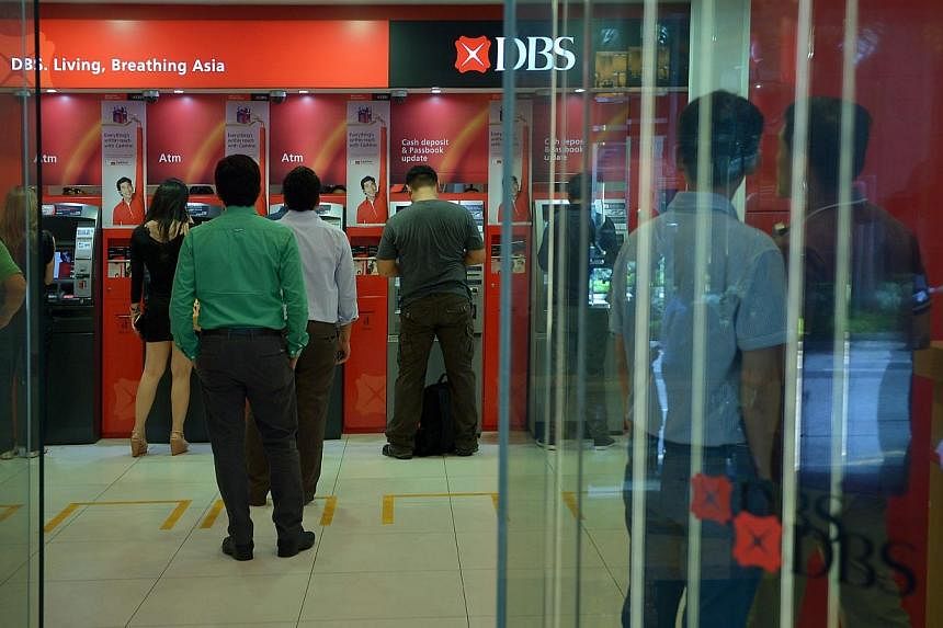 People queueing up at DBS Bank Automated Teller Machines (ATMs) at Shenton Way on Sept 11, 2013.&nbsp;DBS Bank has launched a new service to enable its customers to access simple transactions from their accounts using SMSes. -- PHOTO: ST FILE