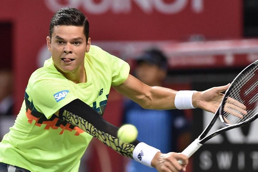 Milos Raonic of Canada returns a shot against Kei Nishikori of Japan during their men's singles final at the Japan Open tennis tournament in Tokyo on Oct 5, 2014.&nbsp;Top seed Milos Raonic suffered a setback in his hopes of qualifying for the season