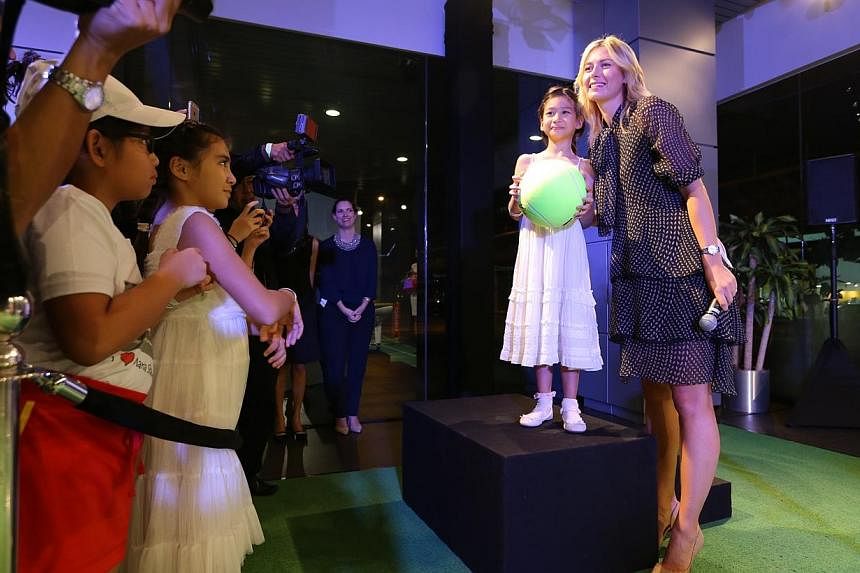 Maria Sharapova at an auction to raise funds for Straits Times Pocket Money Fund at the Porsche showroom. -- ST PHOTO: ONG WEE JIN