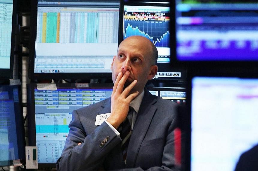 A trader works on the floor of the New York Stock Exchange on Oct 15, 2014 in New York City. As fears from Ebola and a global slowdown spread, stocks plunged on Wednesday with the Dow falling over 400 points during the afternoon before receovering sl