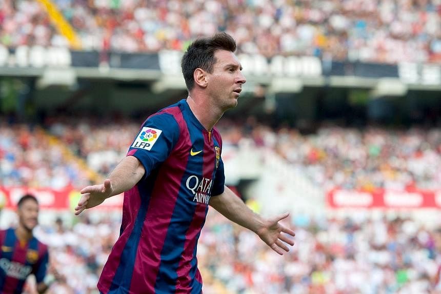 Barcelona's Argentinian forward Lionel Messi celebrates after scoring against Rayo Vallecano at the Vallecas stadium in Madrid on Oct 4, 2014. -- PHOTO: AFP