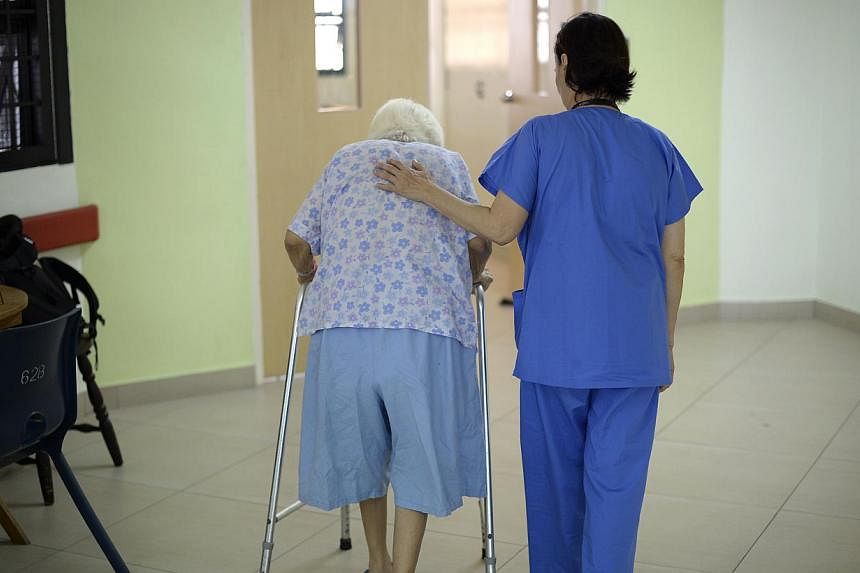 A nurse helping an elderly patient at Institute of Mental Health. When it comes to identifying and taking care of mental health patients, everyone- from friends and family, to grassroots workers and general practitioners - must play a part, says Heal