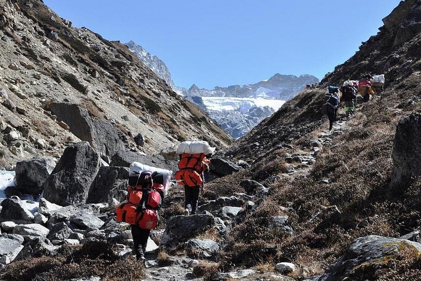 People trekking along the Forbidden Valley in Nepal in 2013. Singapore tour agencies say upcoming treks in Nepal will proceed as planned, following a snowstorm that ripped through the Himalayan region. -- PHOTO:&nbsp;BLACK TOMATO