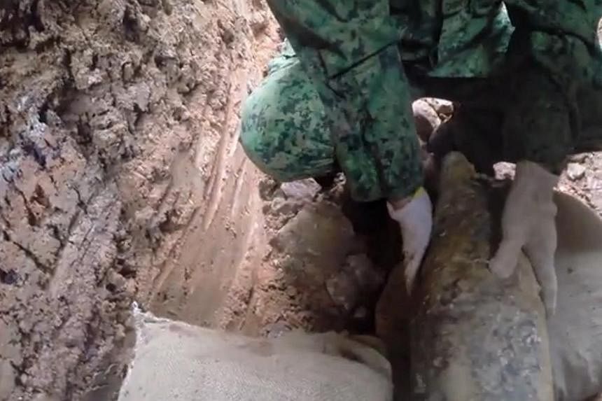 Screengrab of a video posted by the army on the detonation of a war relic, a fused and fired 50kg World War II aerial bomb, at a construction site at Telok Blangah Street 31. -- PHOTO: MINISTRY OF DEFENCE