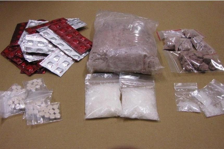 Heroin, ‘Ice’, ‘Ecstasy’ and Erimin-5 seized in a CNB operation on Oct 16, 2014. -- PHOTO: CENTRAL NARCOTICS BUREAU