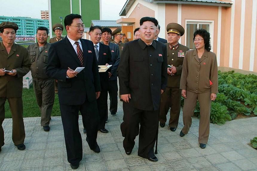 This undated picture released from North Korea's official Korean Central News Agency (KCNA) on October 14, 2014 shows North Korean leader Kim Jong Un smiling as he inspects a newly built housing complex in Pyongyang. Mr Kim has finally resurfaced wit
