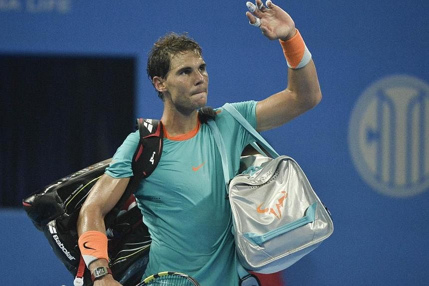 Rafael Nadal of Spain leaves the court after his defeat against Martin Klizan of Slovakia in their men's singles quarter final match at the China Open tennis tournament in the National Tennis Center of Beijing on Oct 3, 2014.&nbsp;-- PHOTO: AFP