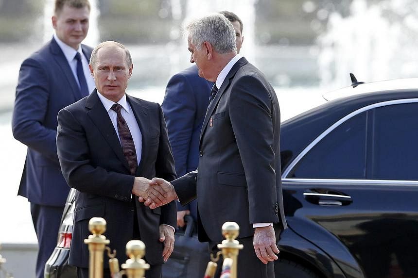 Serbian President Tomislav Nikolic (centre) weclomes Russian President Vladimir Putin outside Serbia Palace building in Belgrade Oct 16, 2014. Serbia laid out the red carpet on Thursday for Russian President Vladimir Putin, on a visit to shore up tie