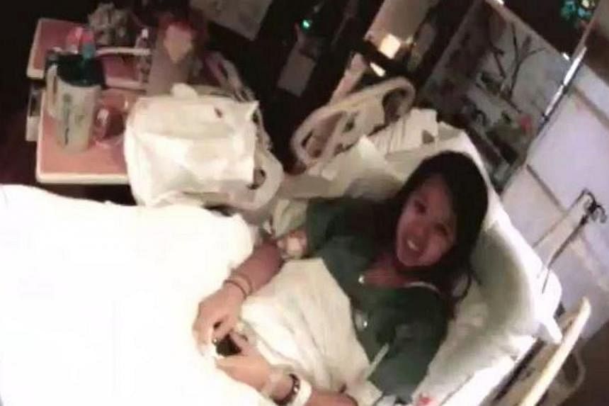 A screengrab from a 56-second video recorded at the Texas Health Presbyterian Hospital Dallas which shows nurse Nina Pham having a brief conversation with her treating physician. -- PHOTO: TEXAS HEALTH RESOURCES/YOUTUBE