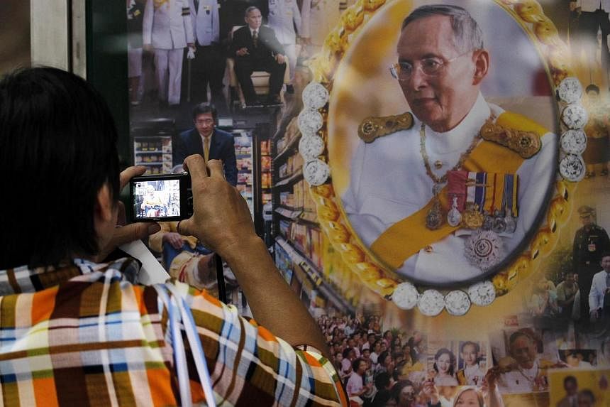A well-wisher takes a picture of Thailand's revered King Bhumibol Adulyadej at the Siriraj hospital in Bangkok. -- PHOTO: REUTERS