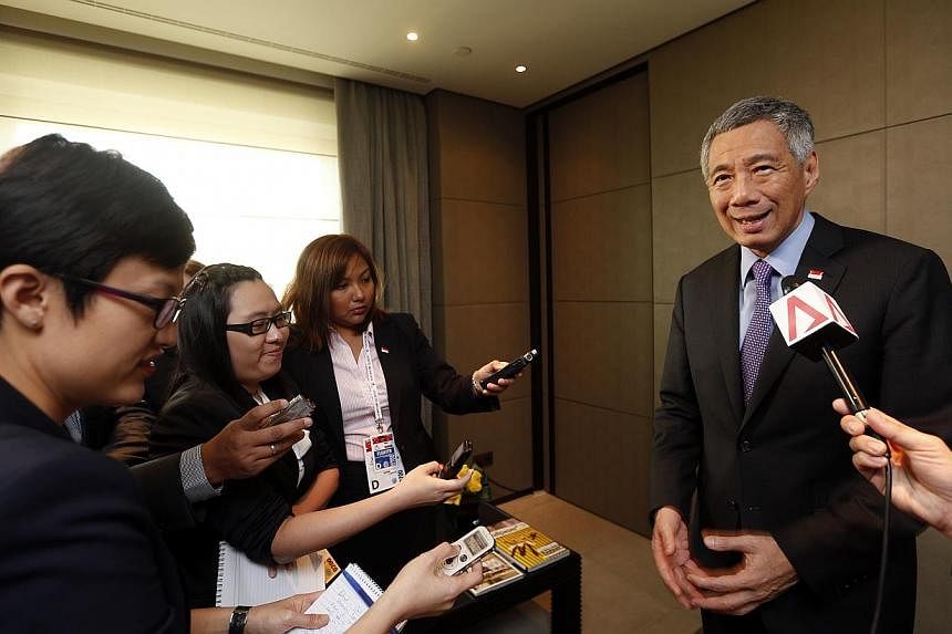 Prime Minister Lee Hsien Loong speaking with Singapore media at the Asem summit in Milan on Oct 17, 2014. -- ST PHOTO:&nbsp;CHEW SENG KIM