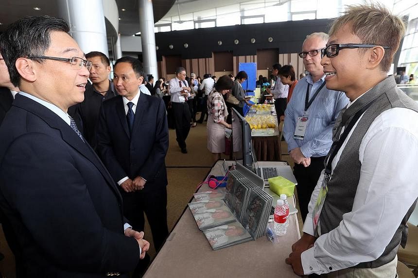 Health Minister Gan Kim Yong with Mr Suf Supiani, 37, who has panic disorder, but is releasing his own album next month called Solitude. They were at the Singapore Mental Health Conference yesterday.