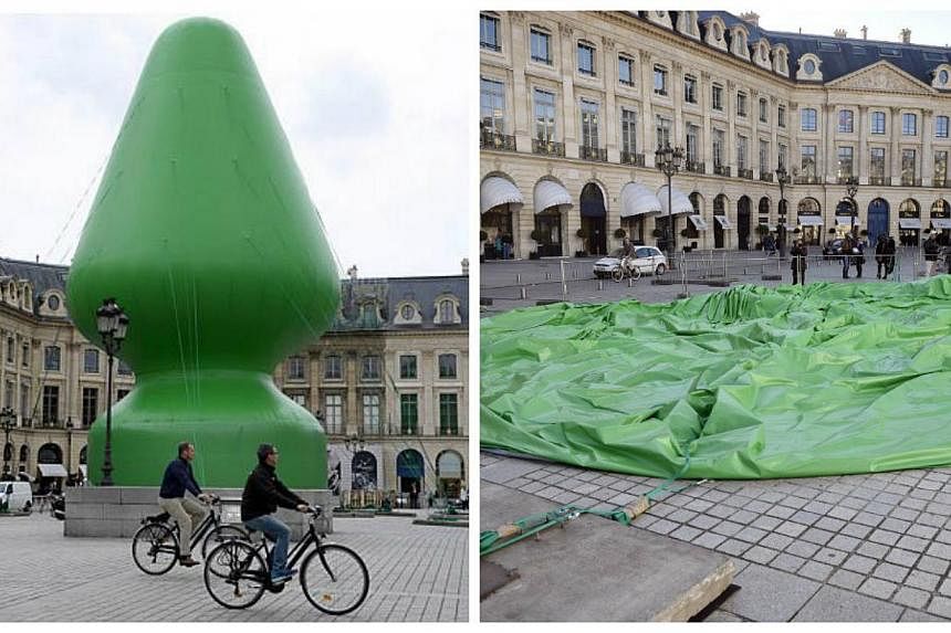 The controversial, inflatable sculpture "Tree" by US artist Paul McCarthy (left) sits deflated on the Vendome square in the centre of Paris (right) on Oct 18, 2014 after vandals cut the cables securing it to the ground overnight and tampered with the
