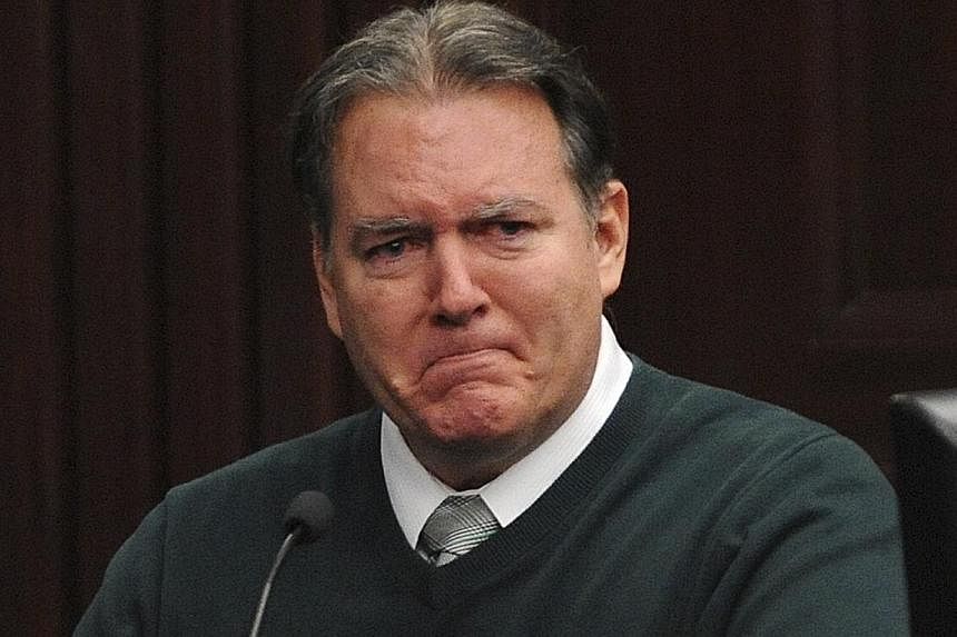 Defendant Michael Dunn reacts on the stand during testimony in his own defence during his murder trial in Duval County Courthouse in Jacksonville, Florida in this photo taken Feb 11, 2014. Dunn, who fatally shot a black teenager during an argument ov