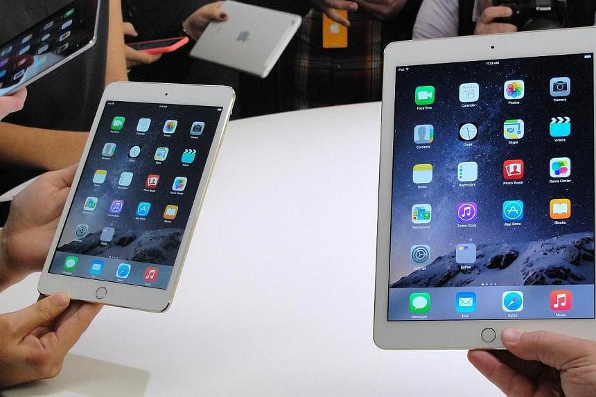 Apple's new iPad mini 3 (left) and iPad Air 2 (right) during an event unveiling the devices in Cupertino, California. -- PHOTO: AFP