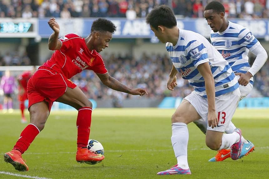 Queens Park Rangers Yoon Suk-Young (centre) and Leroy Fer (right) challenge Liverpool's Raheem Sterling during their English Premier League football match at Loftus Road in London on October 19, 2014.&nbsp;-- PHOTO: REUTERS