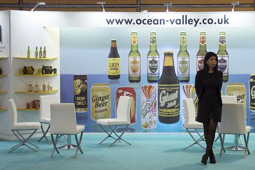 A woman waits in a British stand displaying drinks at the SIAL (Salon International de l'Agroalimentaire, Global Food Show), on Oct 19, 2014, in Villepinte, north-east of Paris. -- PHOTO: AFP