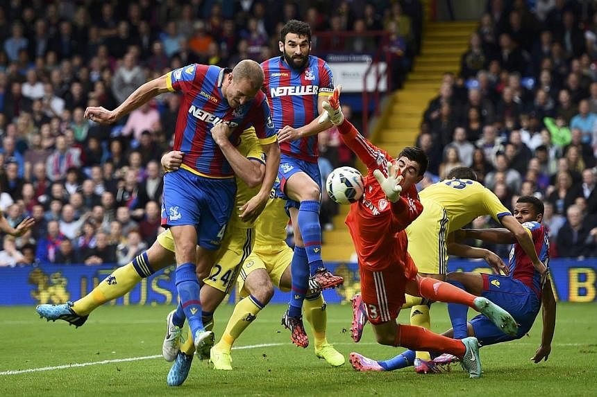 Crystal Palace's Brede Hangeland (left) has a header saved during their English Premier League soccer match against Chelsea at Selhurst Park in London Oct 18, 2014. -- PHOTO: REUTERS