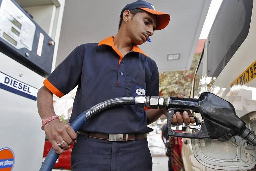 A worker fills a vehicle with diesel at a fuel station in the western Indian city of Ahmedabad in this January 2013 file photo.&nbsp;India said Saturday it was freeing diesel prices from government control, marking another step to ease the state's gr