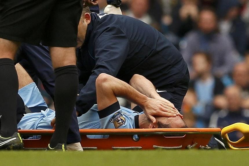 Manchester City's Frank Lampard is carried off injured during their English Premier League soccer match against Tottenham Hotspur at the Etihad Stadium in Manchester, northern England Oct 18, 2014. -- PHOTO: REUTERS