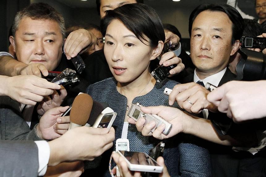 Japan's Economy, Trade and Industry Minister Yuko Obuchi (centre) is surrounded by reporters as she speaks in Tokyo, in this photo taken by Kyodo on Oct 18, 2014. -- PHOTO: REUTERS
