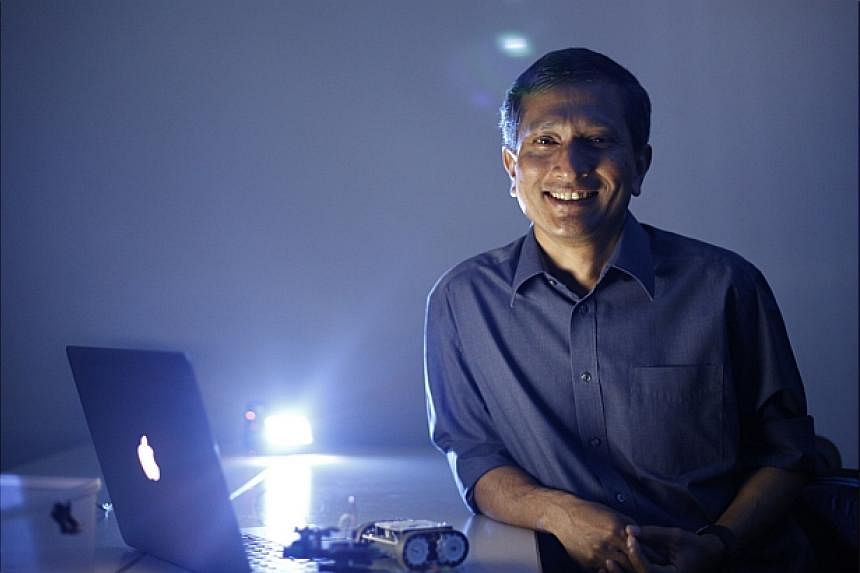 Singapore Minister for Environment and Water Resources Vivian Balakrishnan with some of his gadgets during a media interview at the NUS School of Computing geekcamp on 18 Oct, 2014.&nbsp;-- ST PHOTO: DESMOND LUI