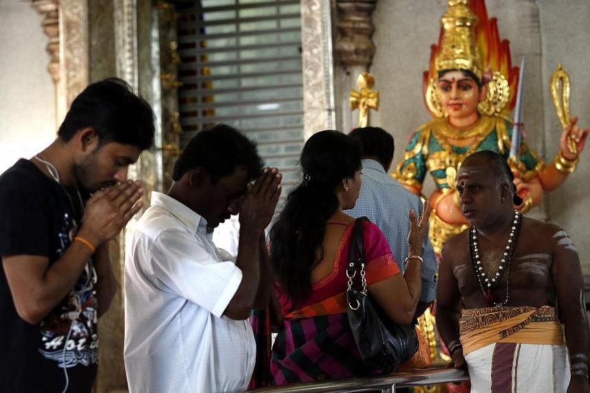 Devotees offer their prayers at Sri Veeramakaliamman Temple in Little India on Oct 19, 2014. -- ST PHOTO: KEVIN LIM
