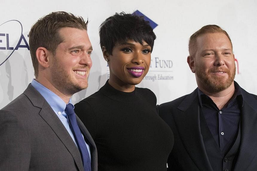(From left to right) Singers Michael Buble and Jennifer Hudson, and honoree and Relativity Founder and CEO Ryan Kavanaugh pose at the 20th Annual Fulfillment Fund Stars benefit gala in Beverly Hills, California on Oct 14, 2014. -- PHOTO: REUTERS