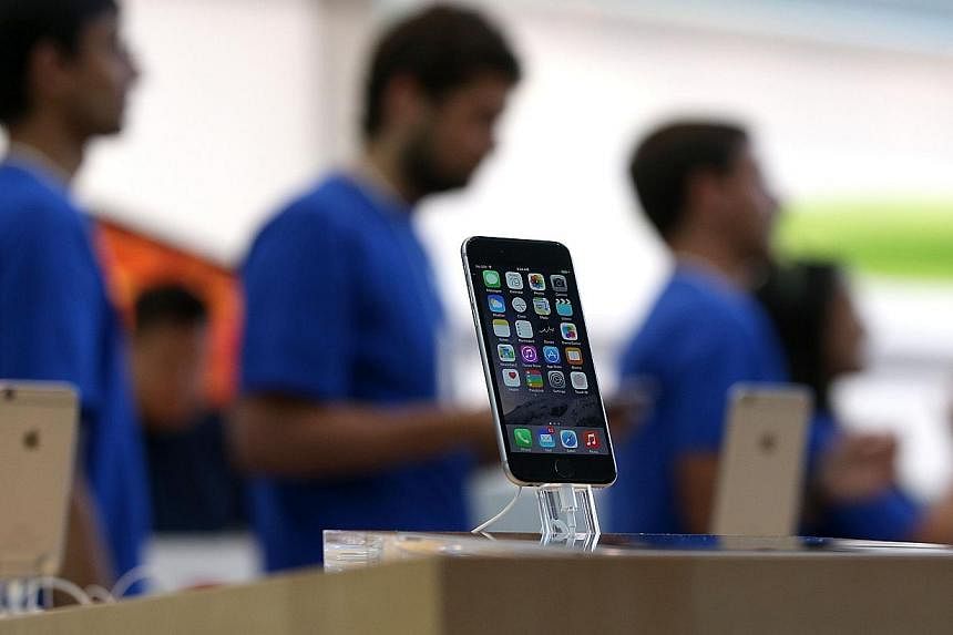 Booming shipments of the iPhone 6 helped Taiwan's export orders jump 12.7 per cent in September year-on-year to a record US$43.3 billion (S$55 billion), the government said on Monday. -- PHOTO: AFP