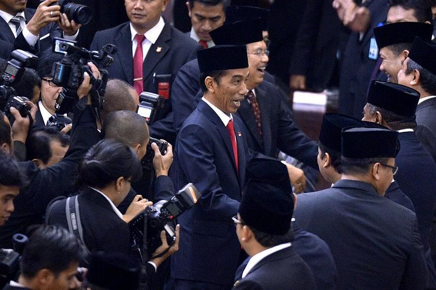 Newly appointed Indonesian President Joko Widodo (middle) being congratulated after his inauguration. -- ST PHOTO: LIM SIN TAI