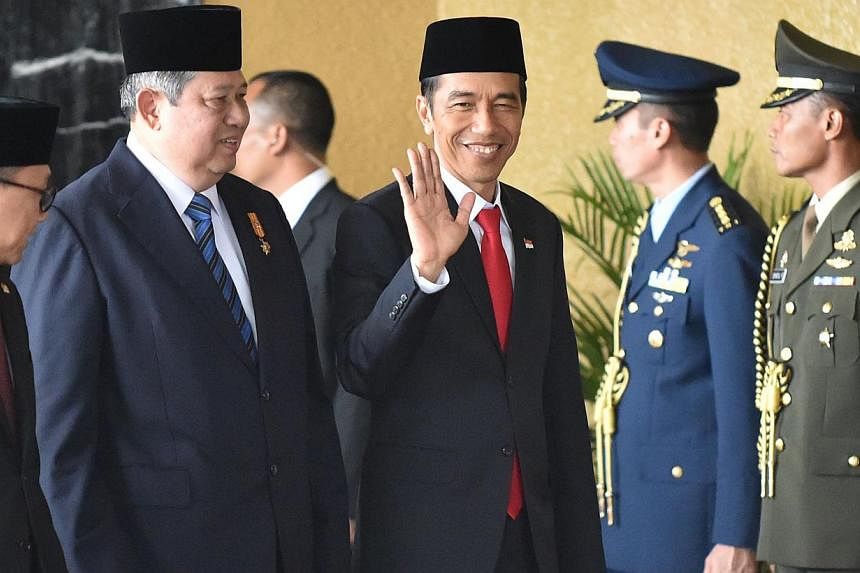 Indonesia President Susilo Bambang Yudhoyono (second from left) and president-elect Joko Widodo (third from right) arrive before the inaugural ceremony at the House of Representative in Jakarta on Oct 20, 2014. -- PHOTO: AFP