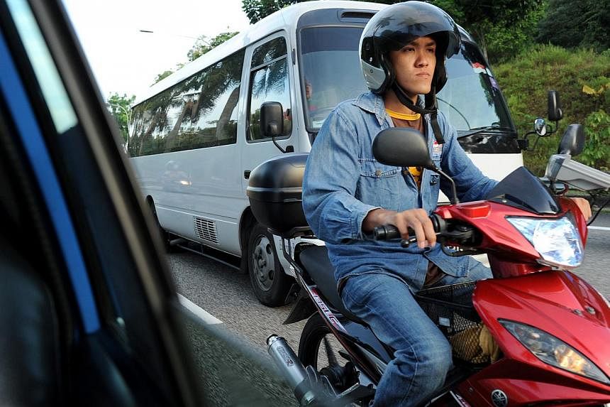 A motorcyclist weaves through the traffic along the BKE. -- ST PHOTO: NG SOR LUAN