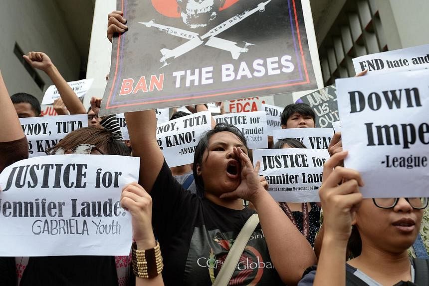 Students holding placards shout anti-US slogans during a protest inside the state university campus in Manila, to condemn the murder of Filipino transgender allegedely by a US marine. But&nbsp;Philippine President Benigno Aquino said on Monday, Oct 2