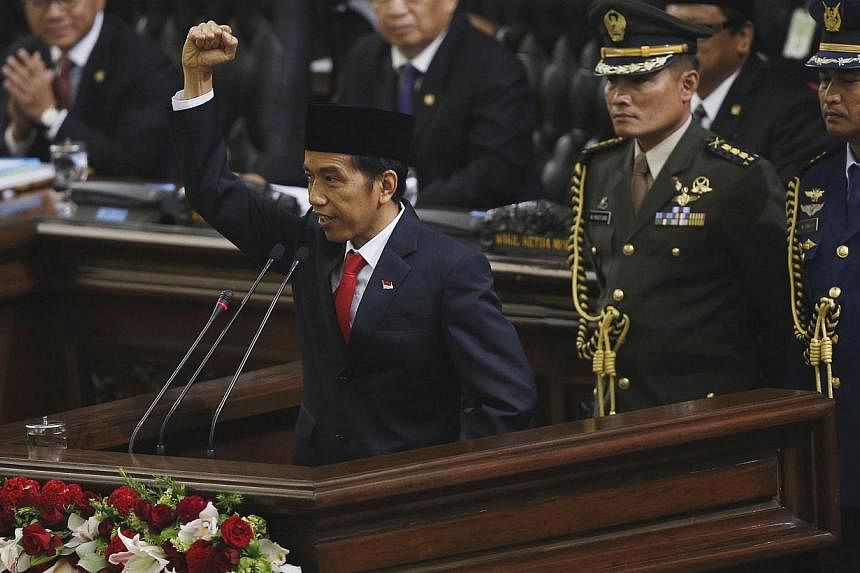 Indonesia's new President Joko Widodo delivering his speech after being inaugurated at the House of Representative building in Jakarta on Oct 20, 2014. -- PHOTO: REUTERS