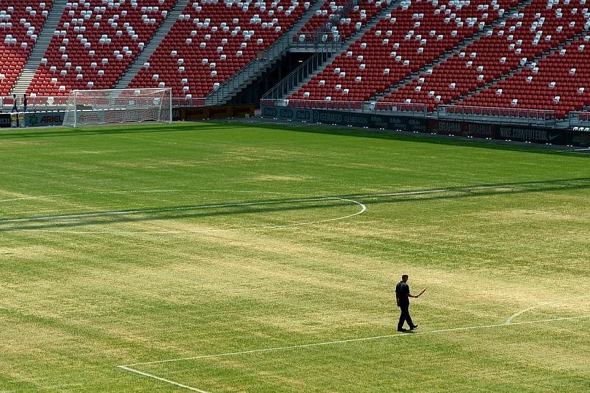 An Oct 13,2014.&nbsp;photo of the National Stadium's pitch shows a patchy surface. The poor quality of the pitch has forced the cancellation of the Maori All Blacks' clash with the invitational Asia-Pacific Barbarians on Nov 15.&nbsp;-- ST PHOTO: JAM